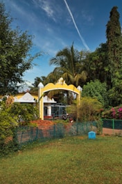 A yellow and white house surrounded by trees