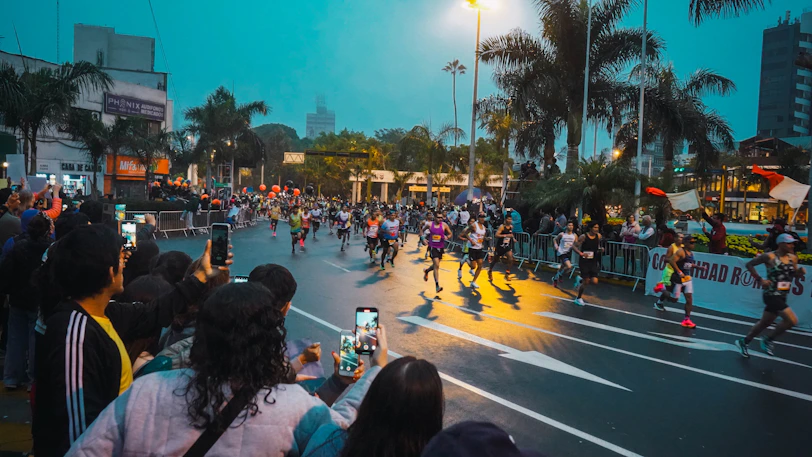 A group of people riding skateboards down a street