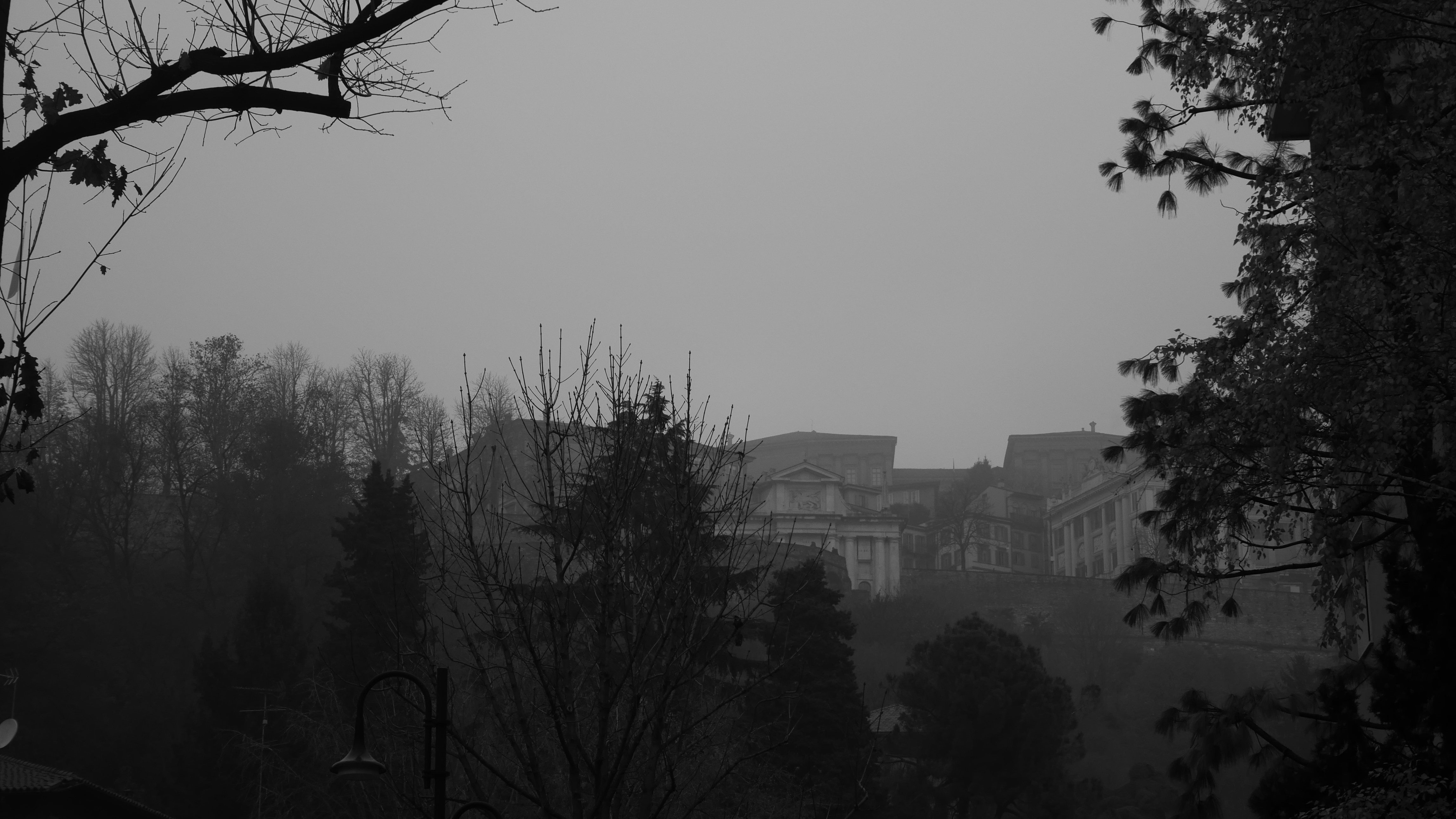 A black and white photo of a foggy city