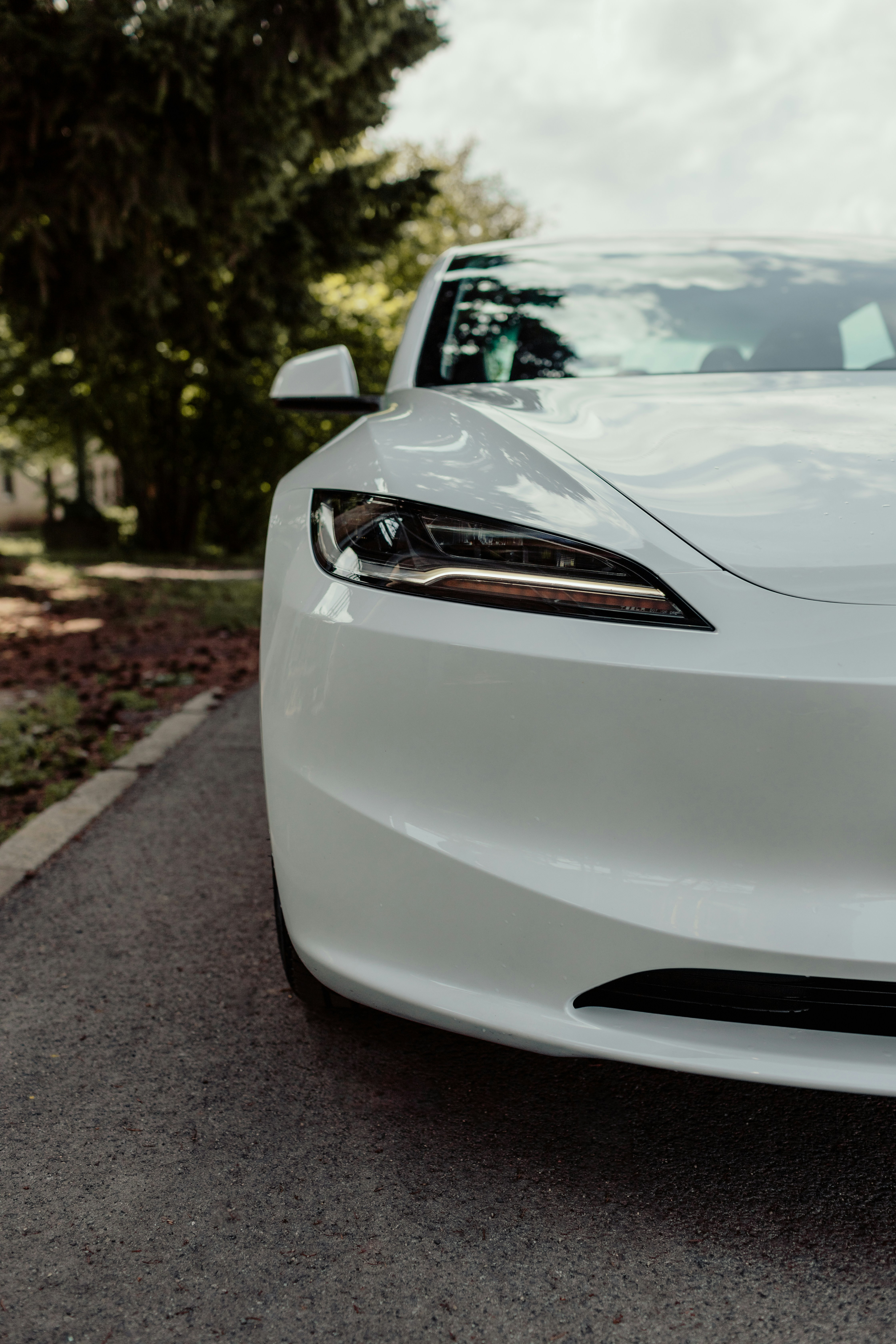A white car parked on the side of the road