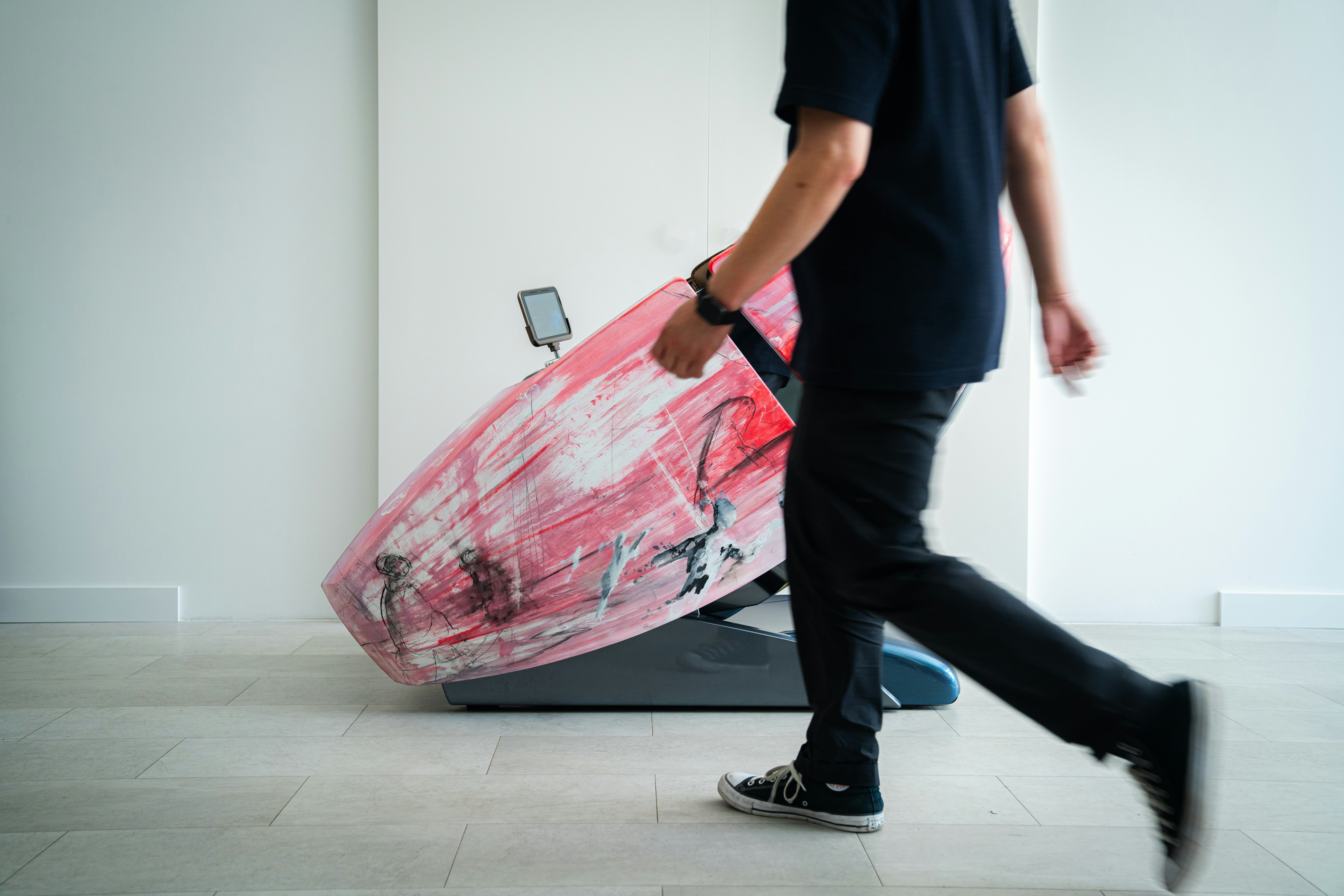 Ein Mann geht mit einem Surfbrett in der Hand