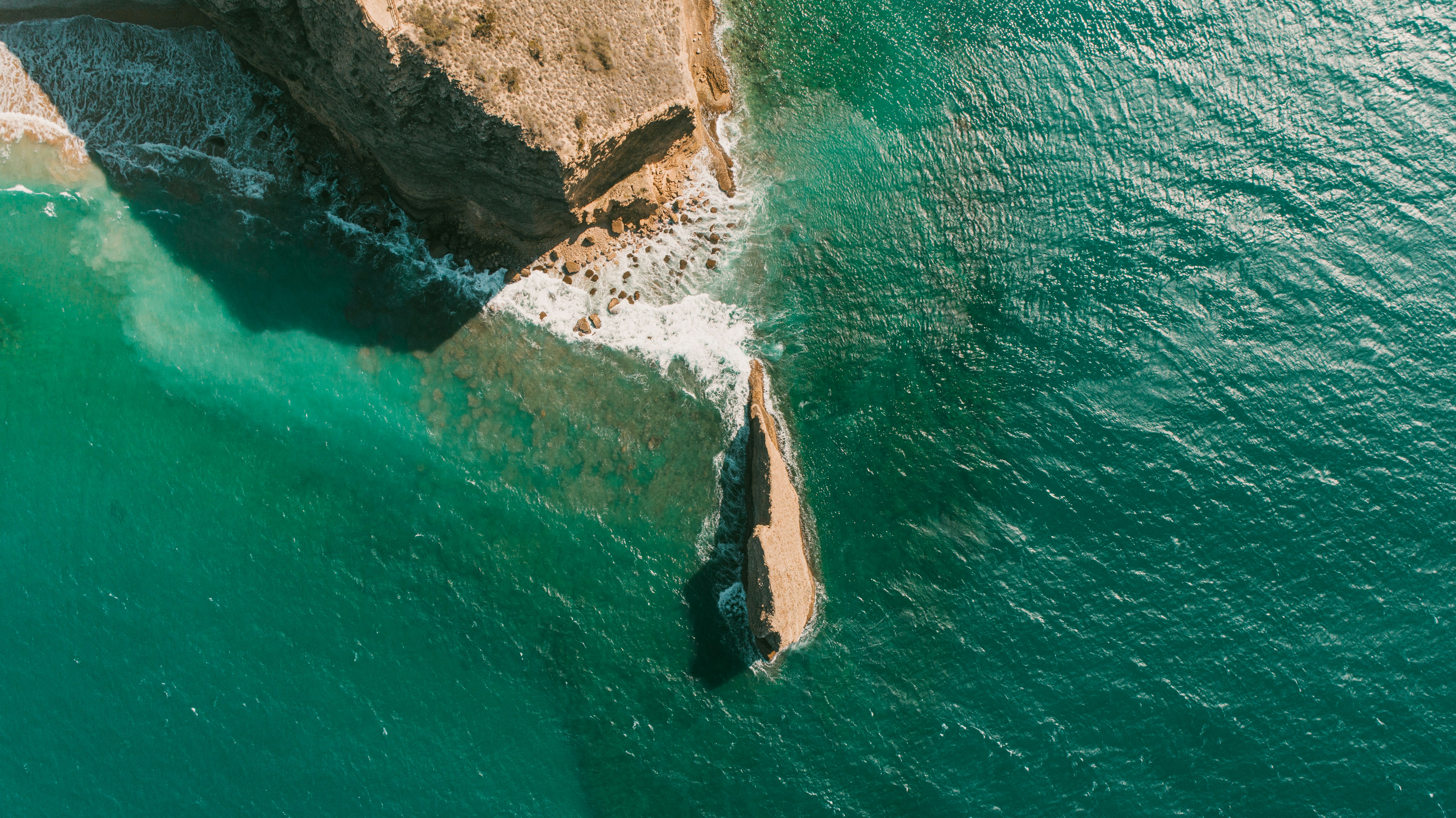 An aerial view of a rock formation in the ocean
