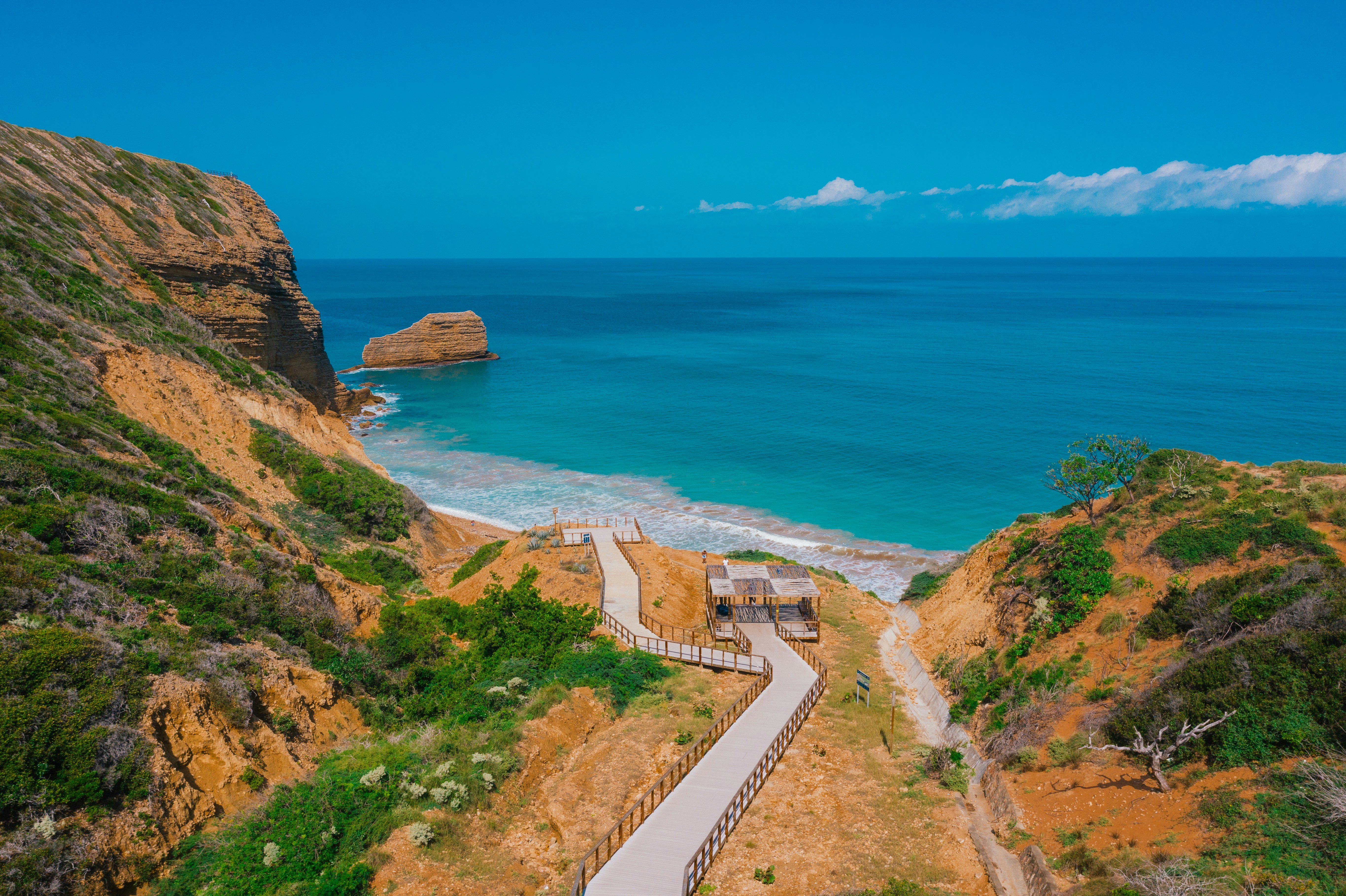 A scenic view of a beach with a path leading to the water