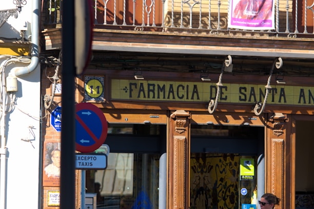 A man walking down the street in front of a store