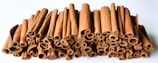 A pile of cinnamon sticks sitting next to each other