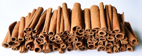 A pile of cinnamon sticks sitting next to each other