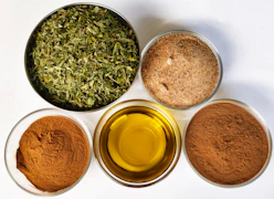 Four bowls filled with different types of spices