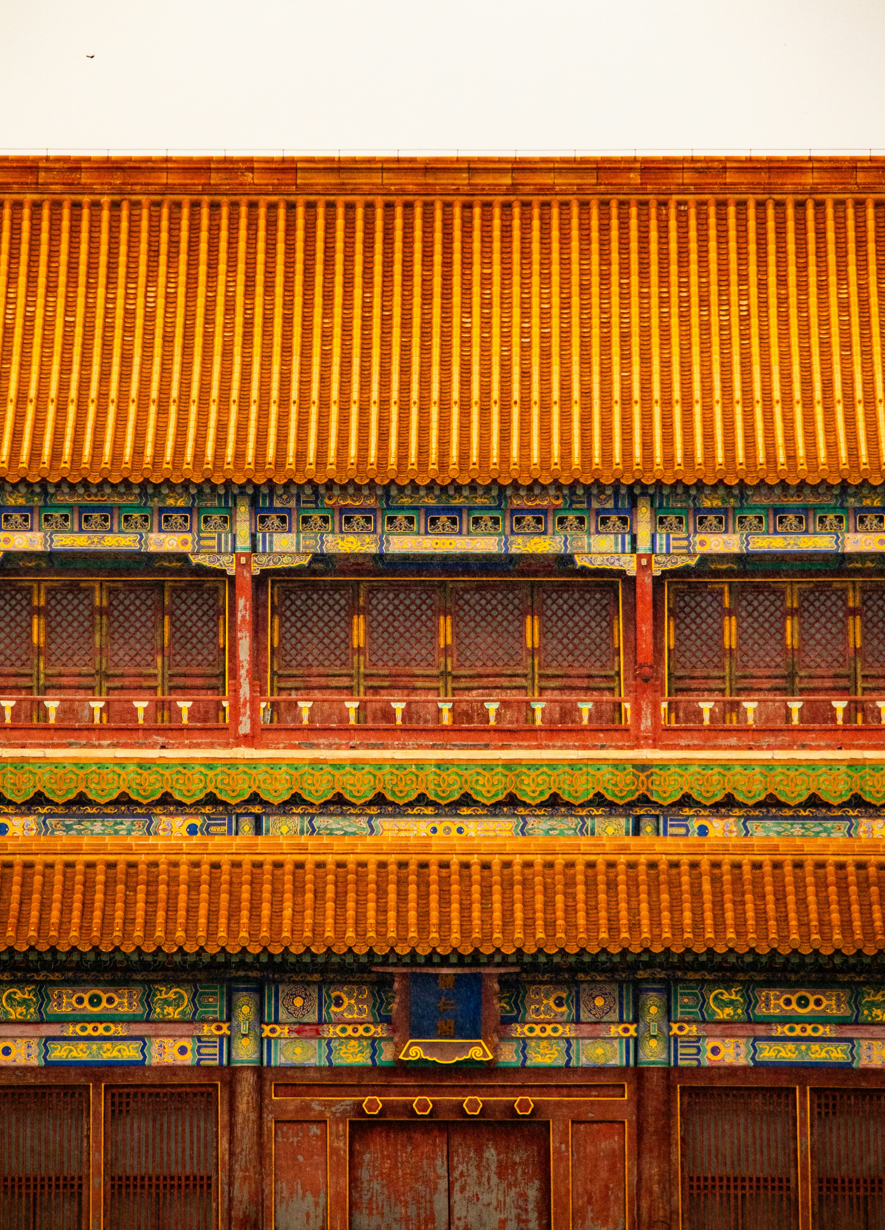 A building with a red door and a yellow roof