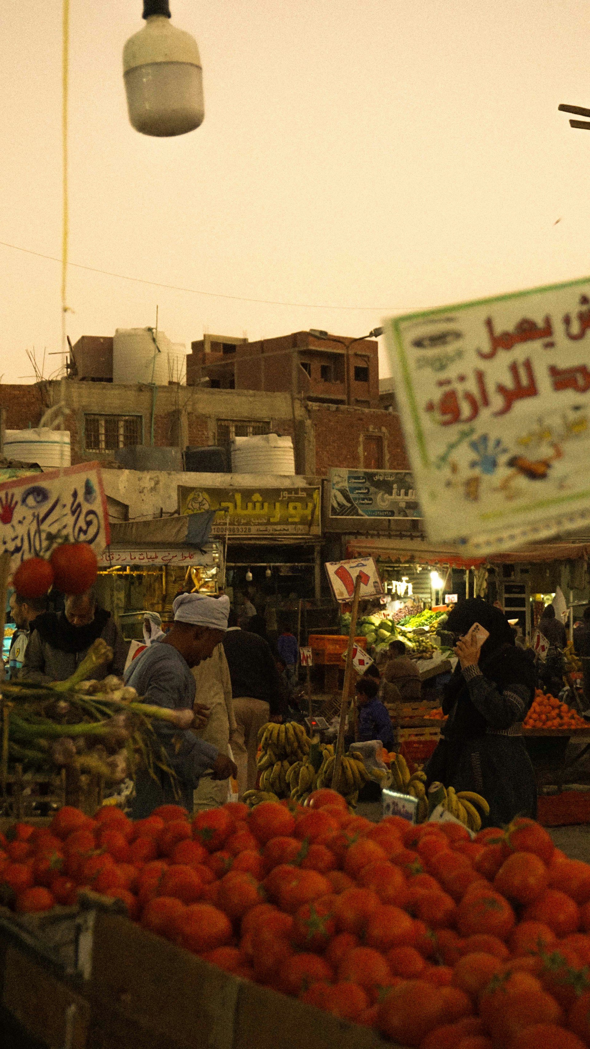 An outdoor market with lots of fruit and vegetables