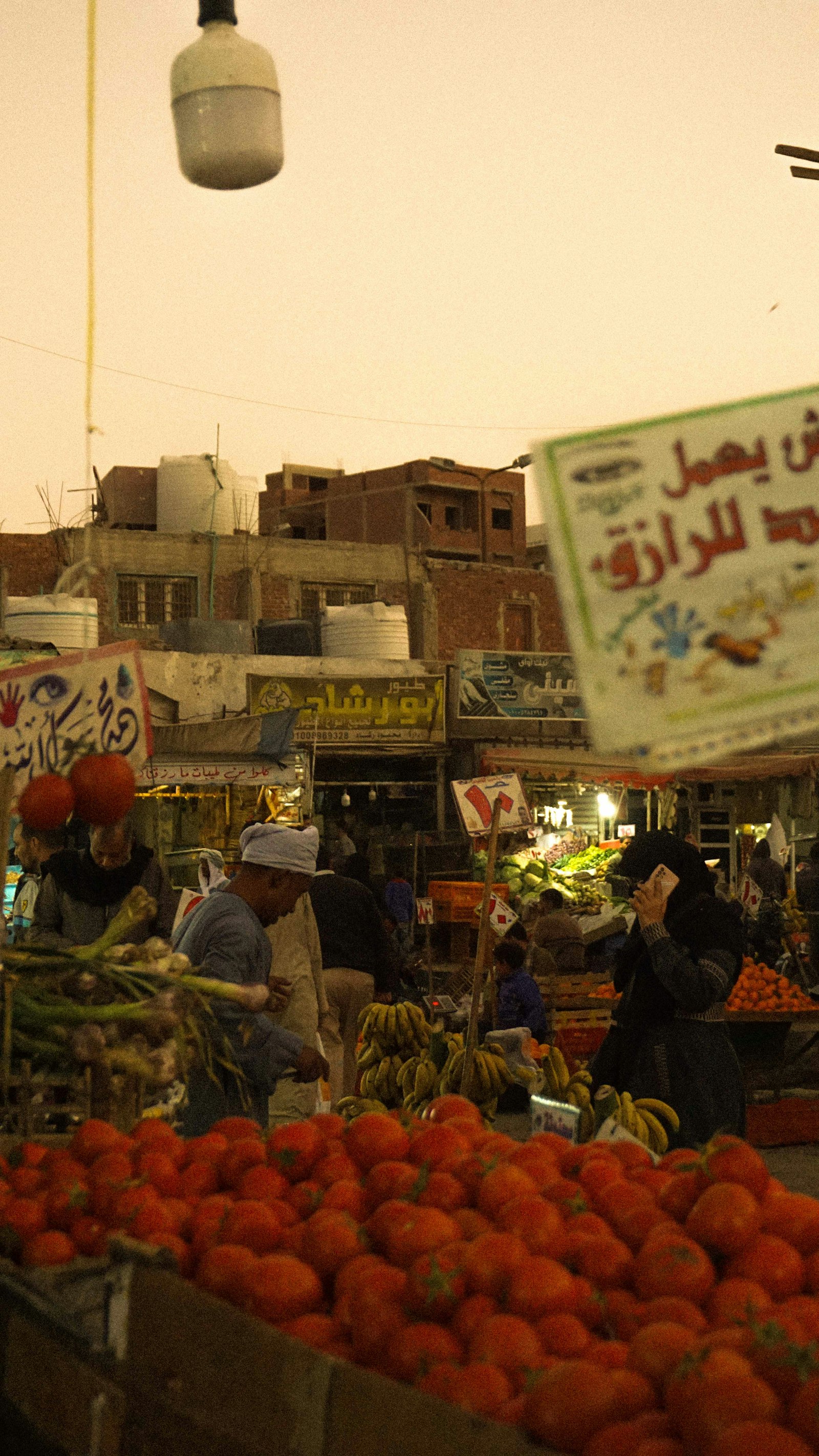 An outdoor Egyptian market stall with fresh fruit and vegetables