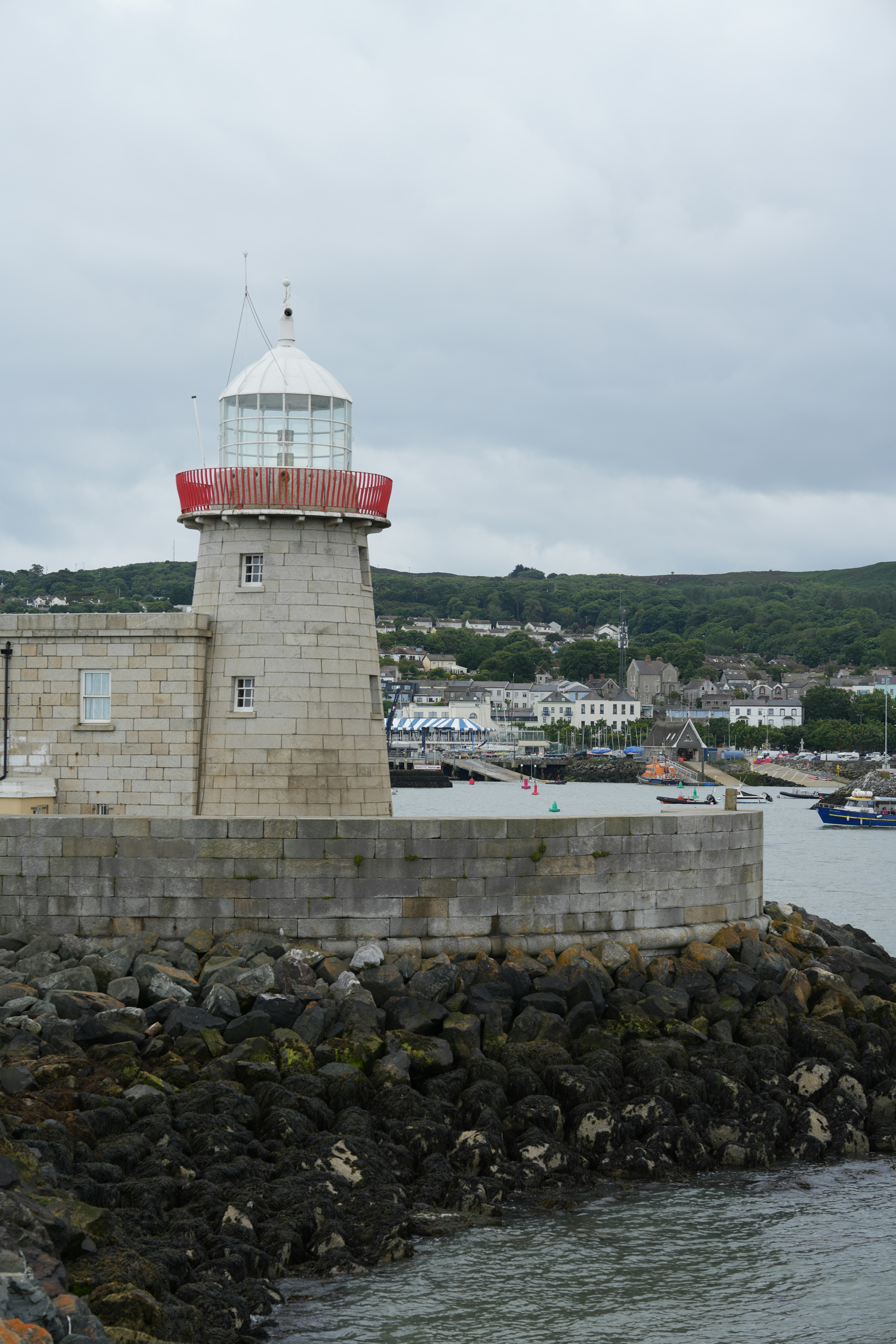 A light house sitting on top of a stone pier