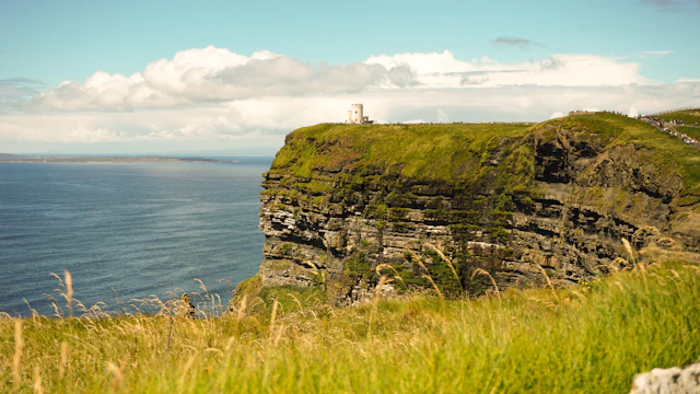A grassy cliff above the open sea