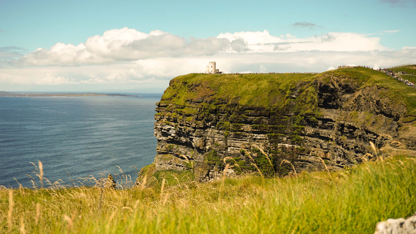 A grassy cliff above the open sea