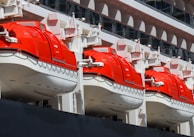 A row of red and white boats sitting next to each other
