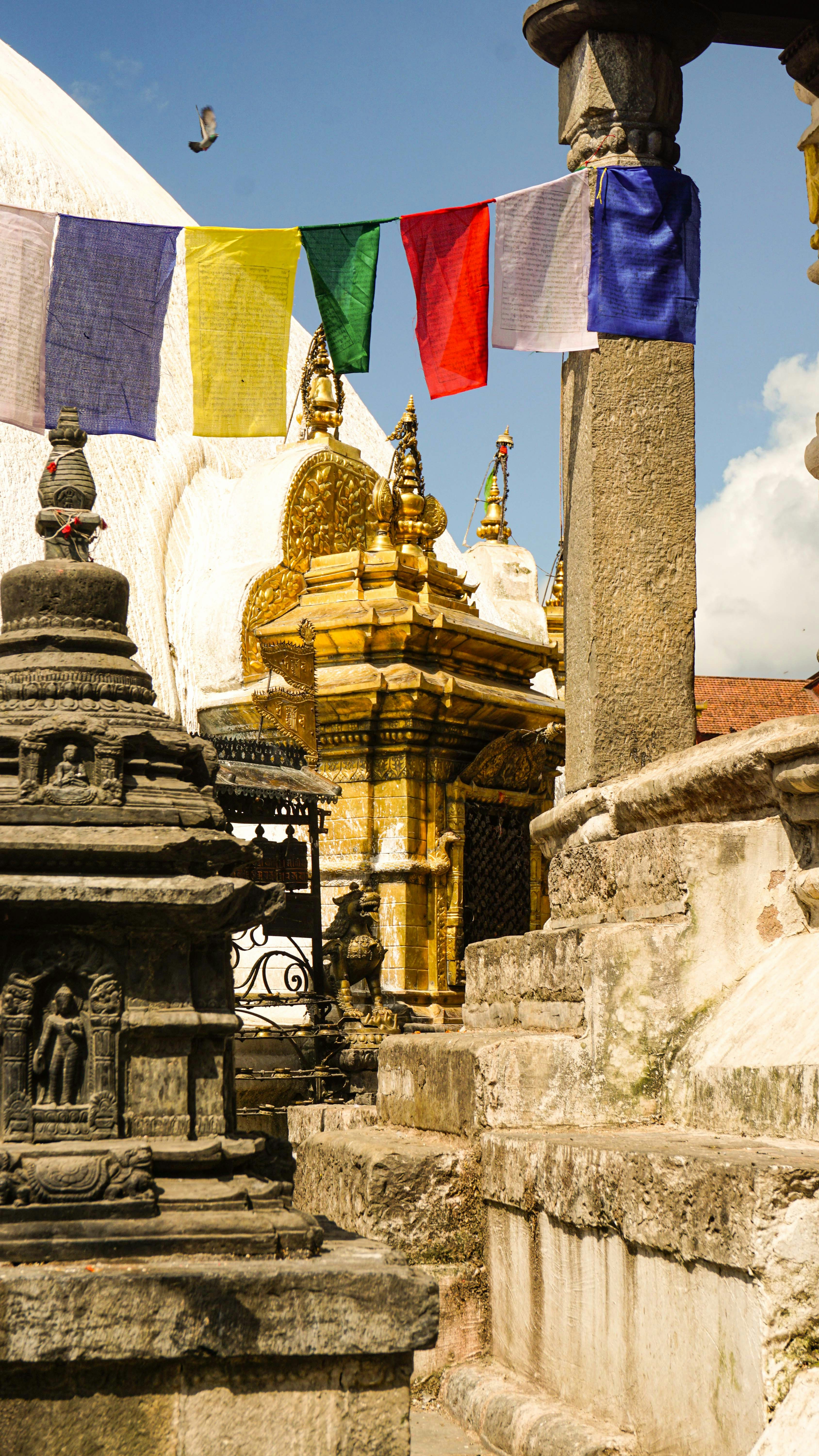 A group of colorful flags hanging from the side of a building