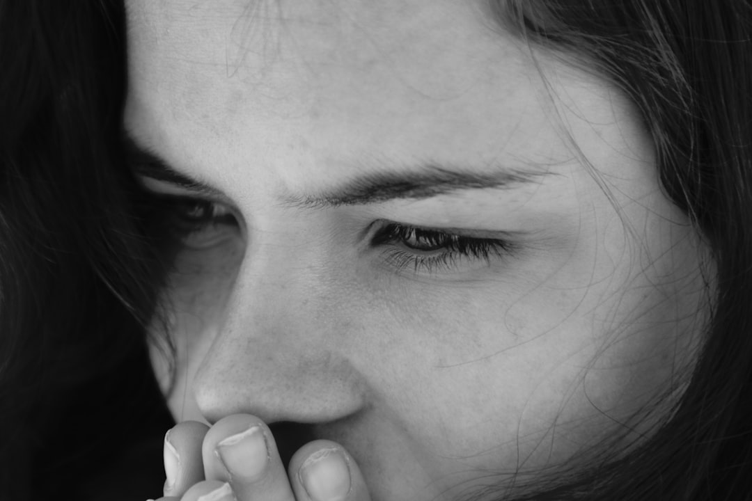 A woman holding her hand to her mouth, Silenced.