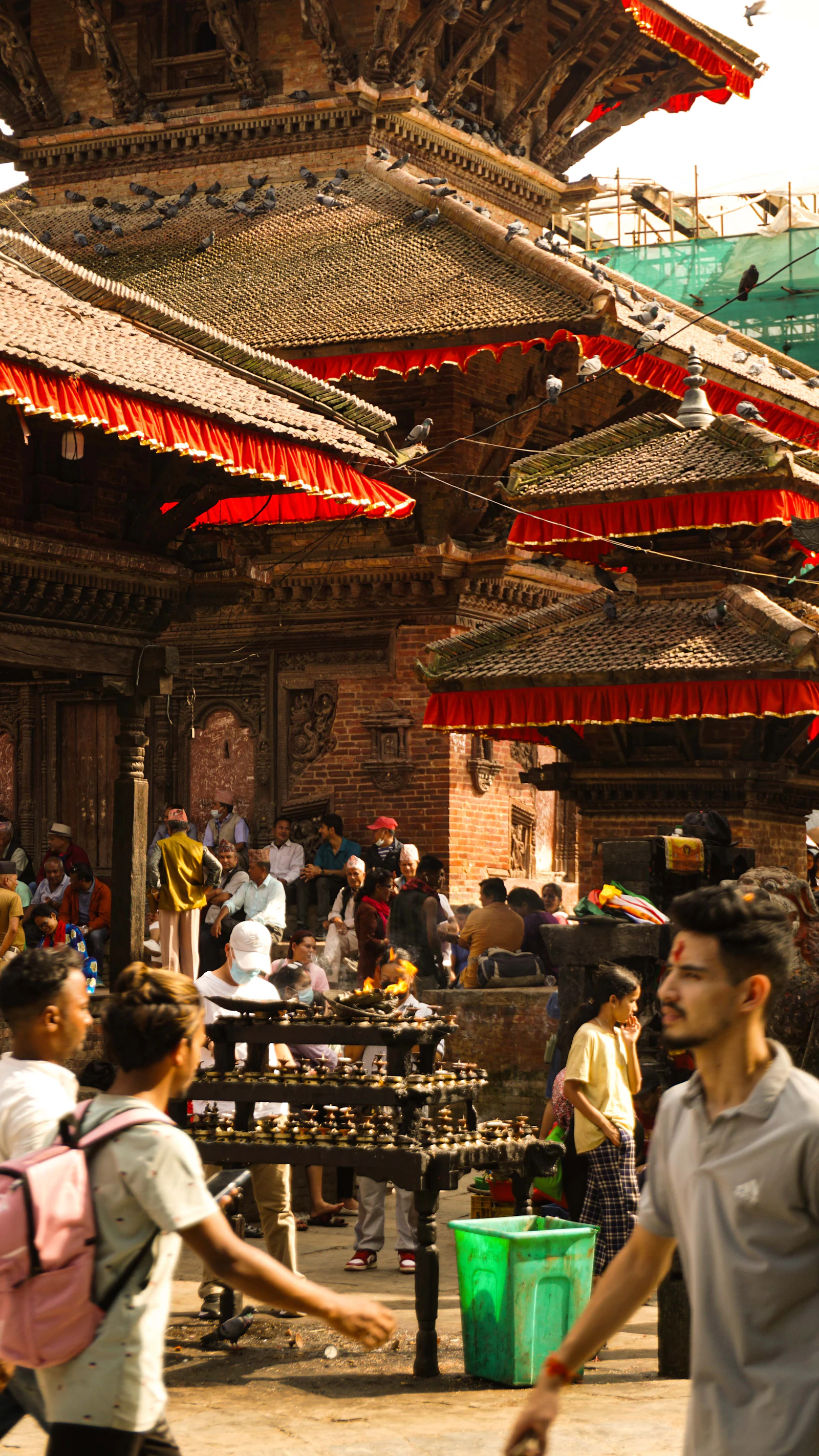 People walking around a heritage building in Kathmandu Nepal