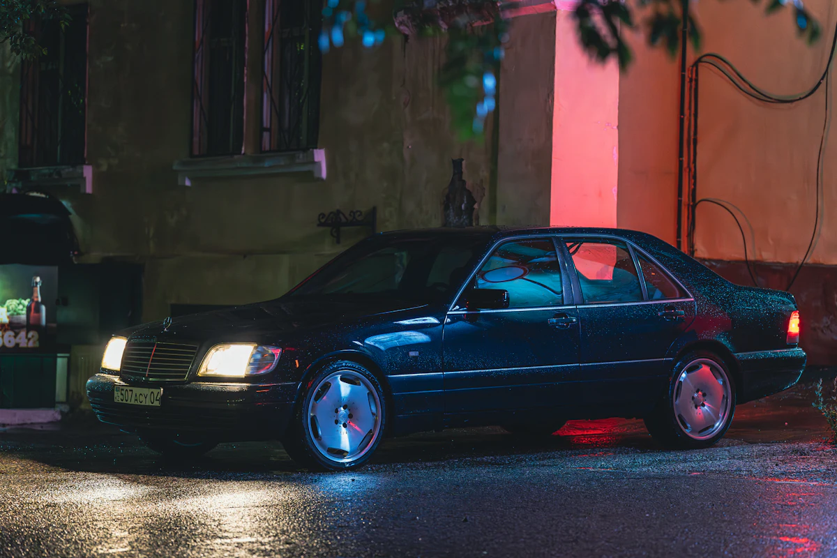 Luxury car waiting at the roadside at night