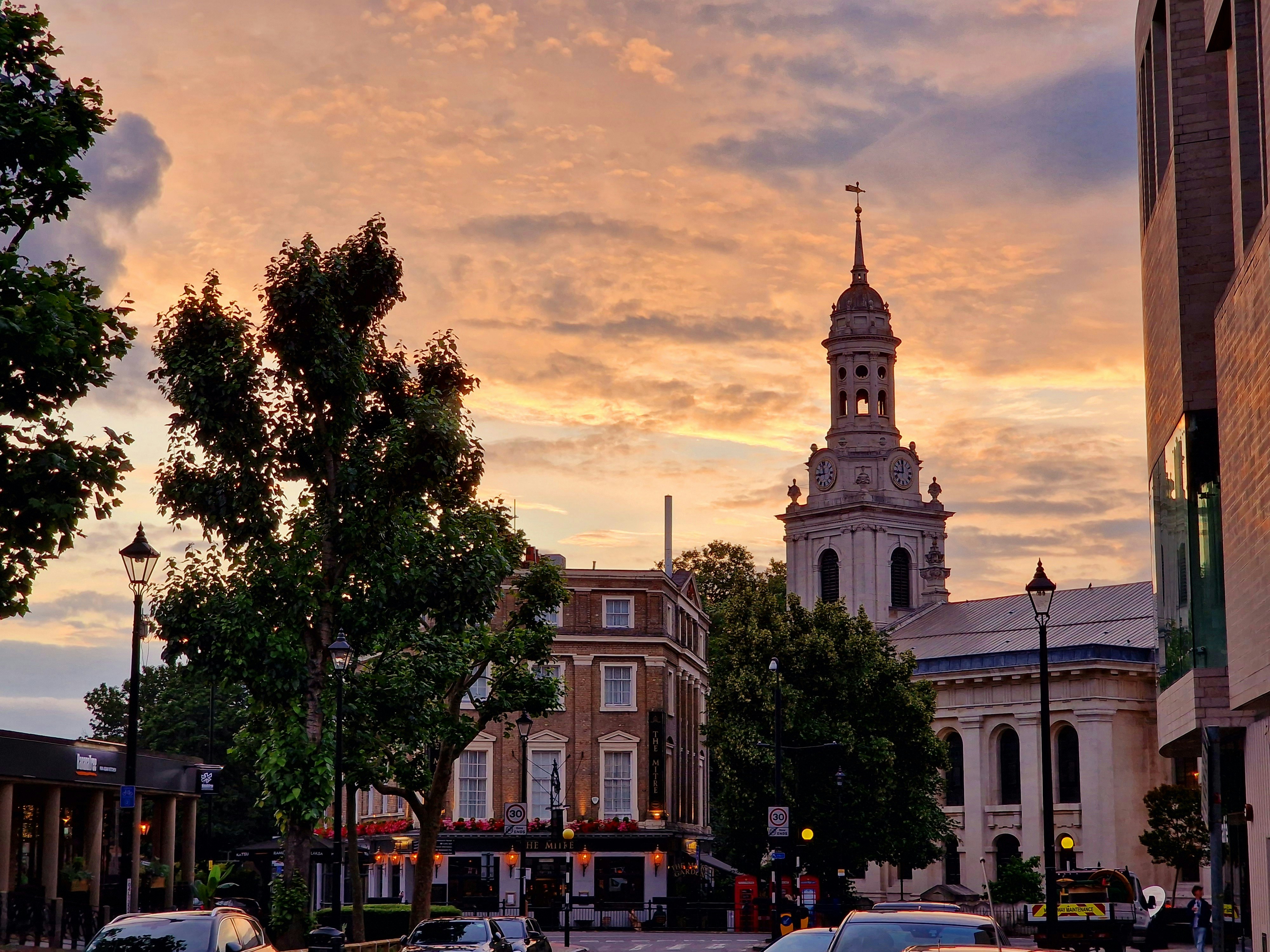 A city street with a clock tower in the background