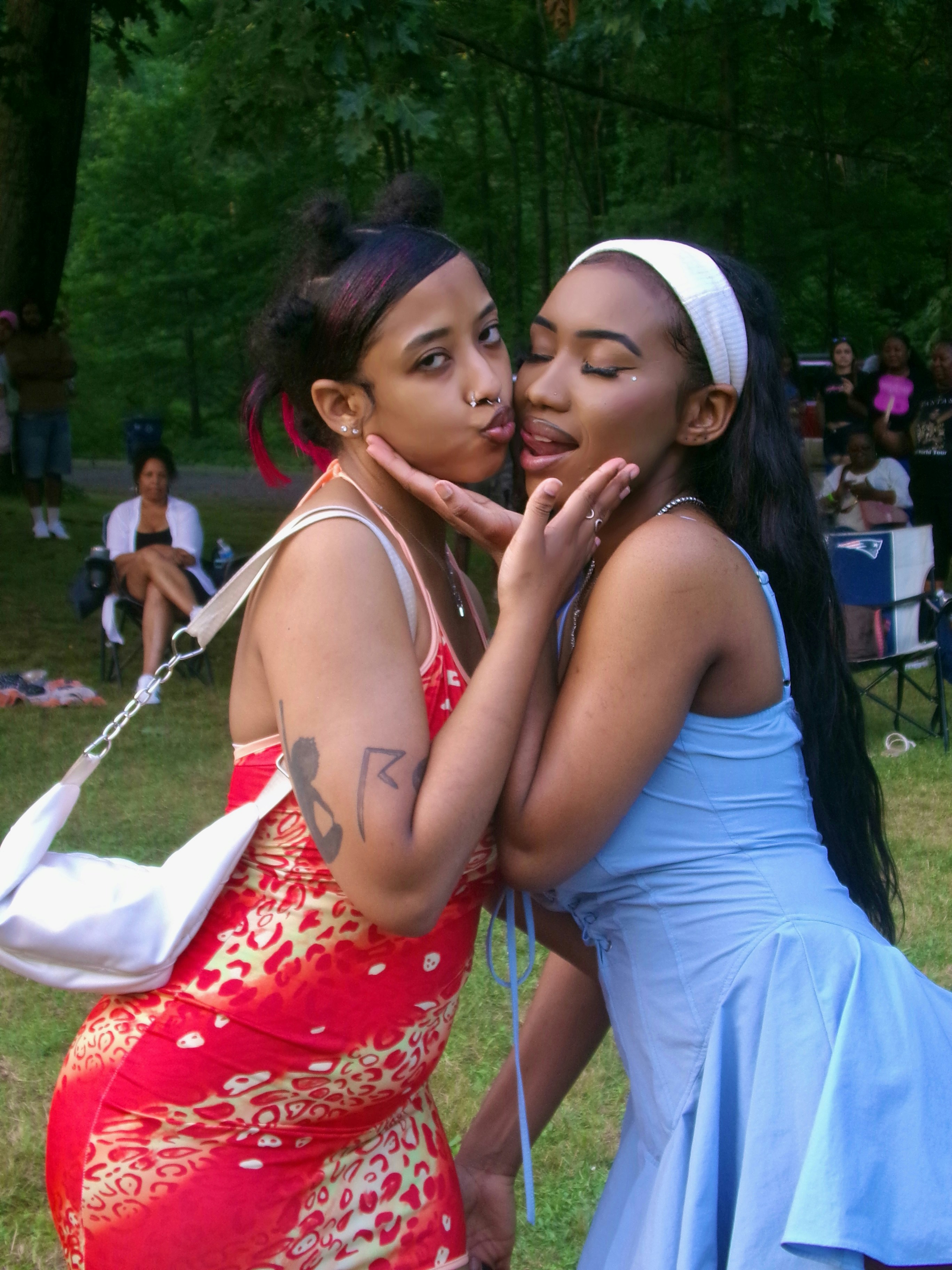 Two women are kissing each other in a park photo – Free Forest Image on ...