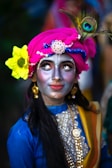 A woman with a painted face and a flower in her hair