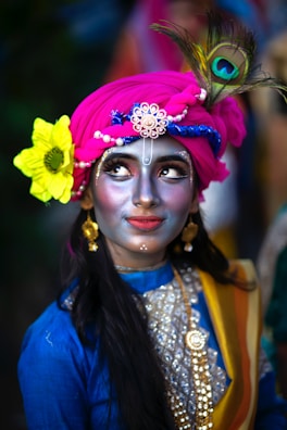 A woman with a painted face and a flower in her hair