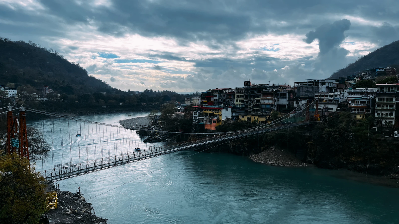 Suspension bridge over the Ganga at Rishikesh with the Himalayan foothills behind