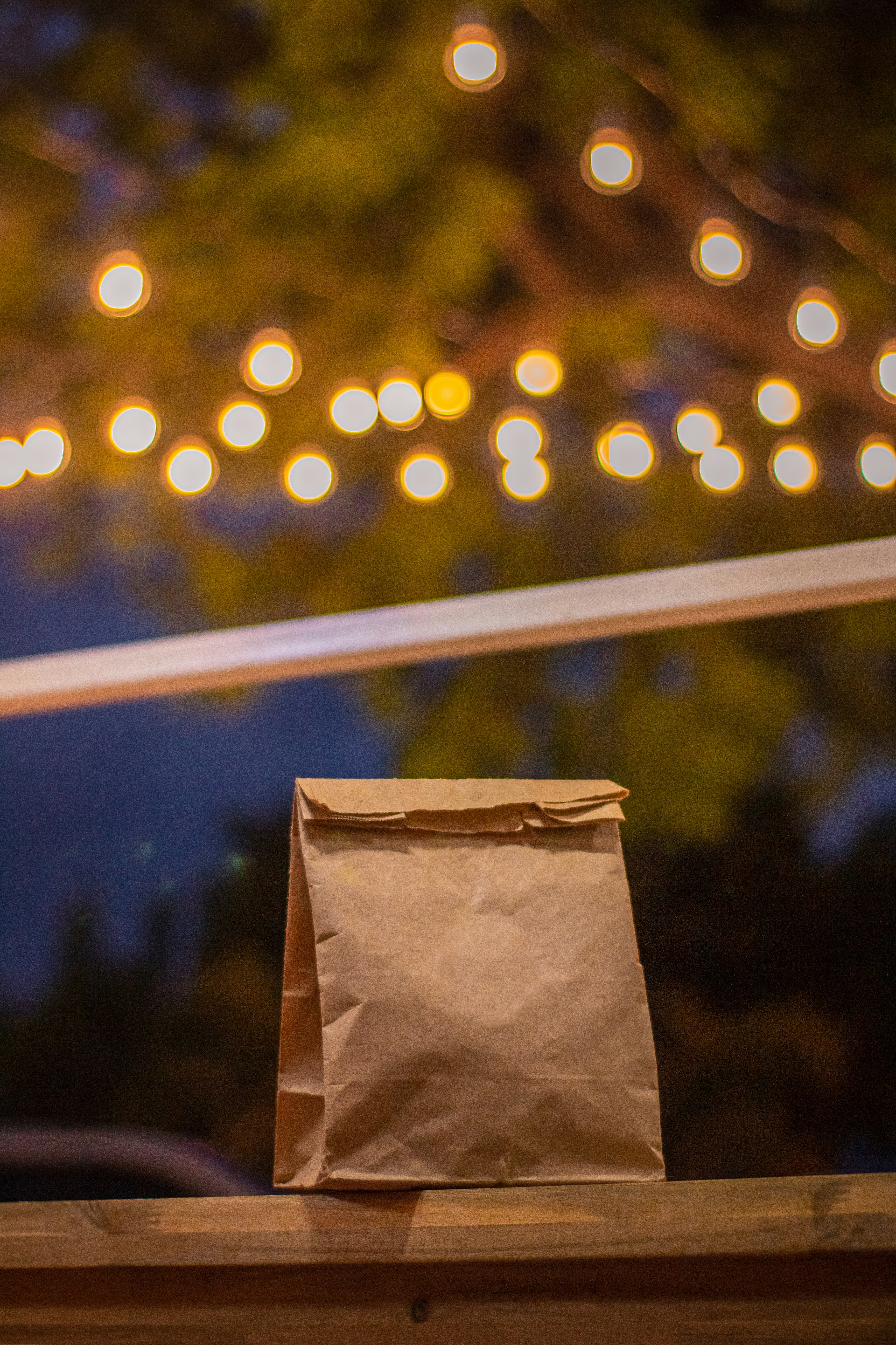 A brown paper bag sitting on top of a wooden table