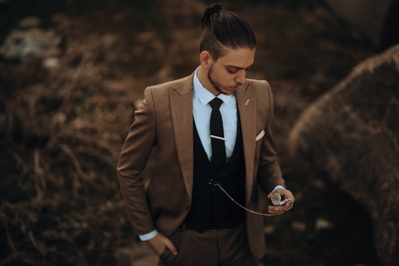 A man in a suit and tie holding a cell phone