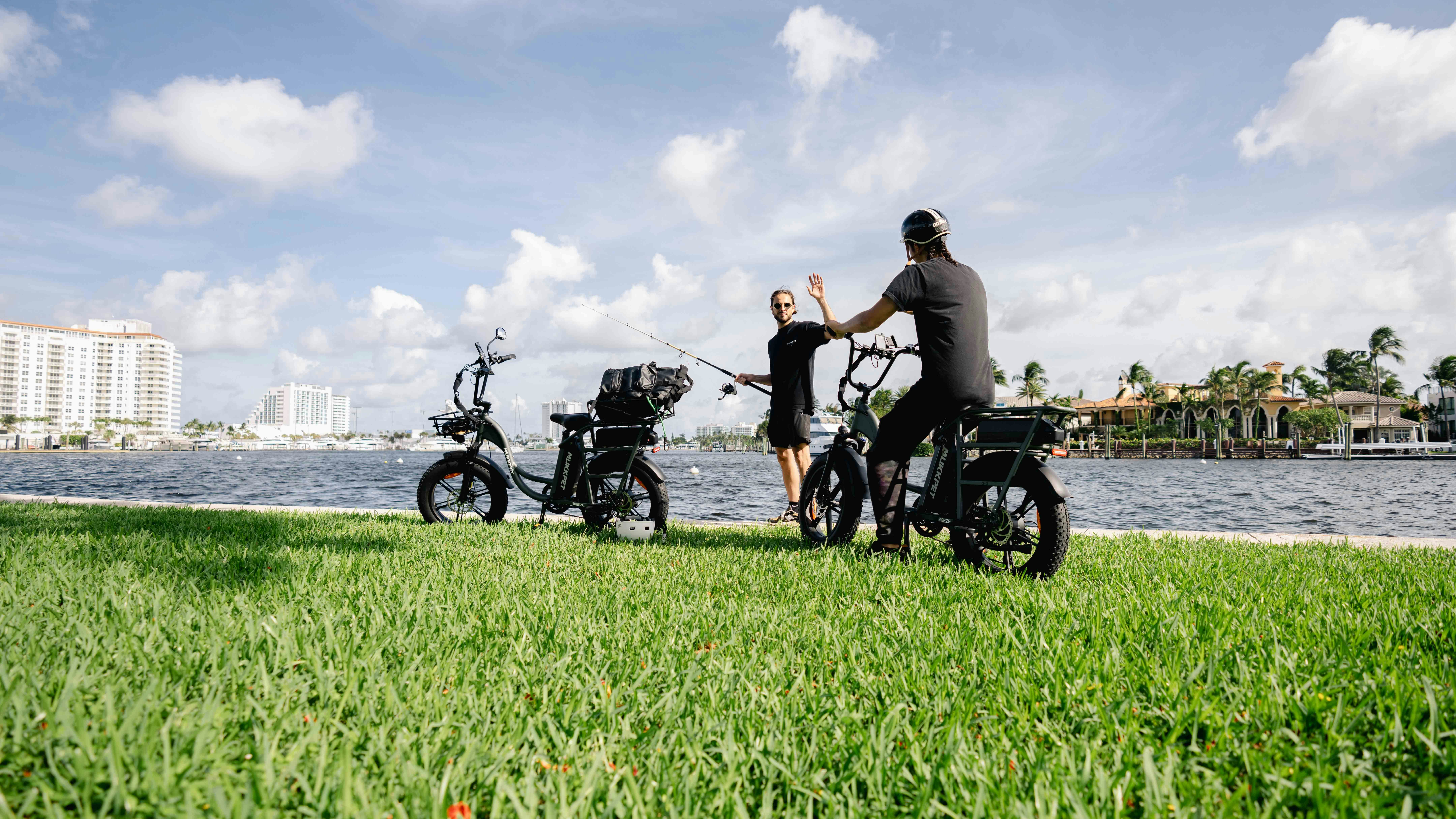 A man riding a bike next to a group of parked bikes