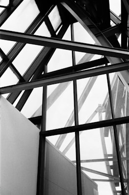 A black and white photo of a building with a clock