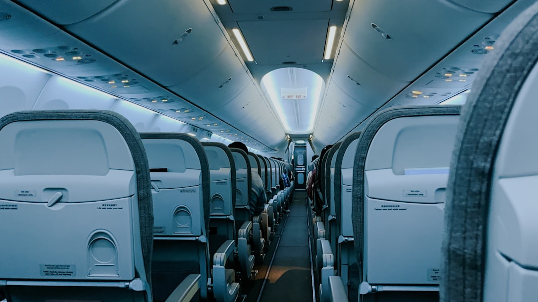The inside of an airplane with rows of empty seats, Late night departure 🛫