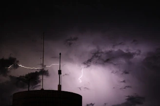 A tower with a lightning bolt in the sky