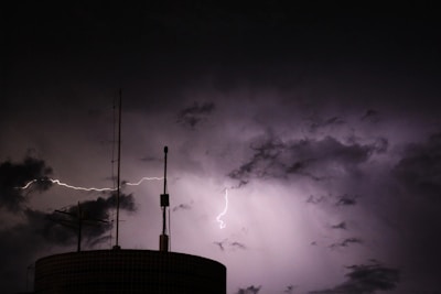 A tower with a lightning bolt in the sky