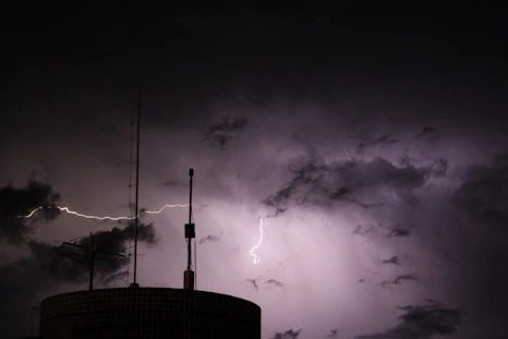 A tower with a lightning bolt in the sky
