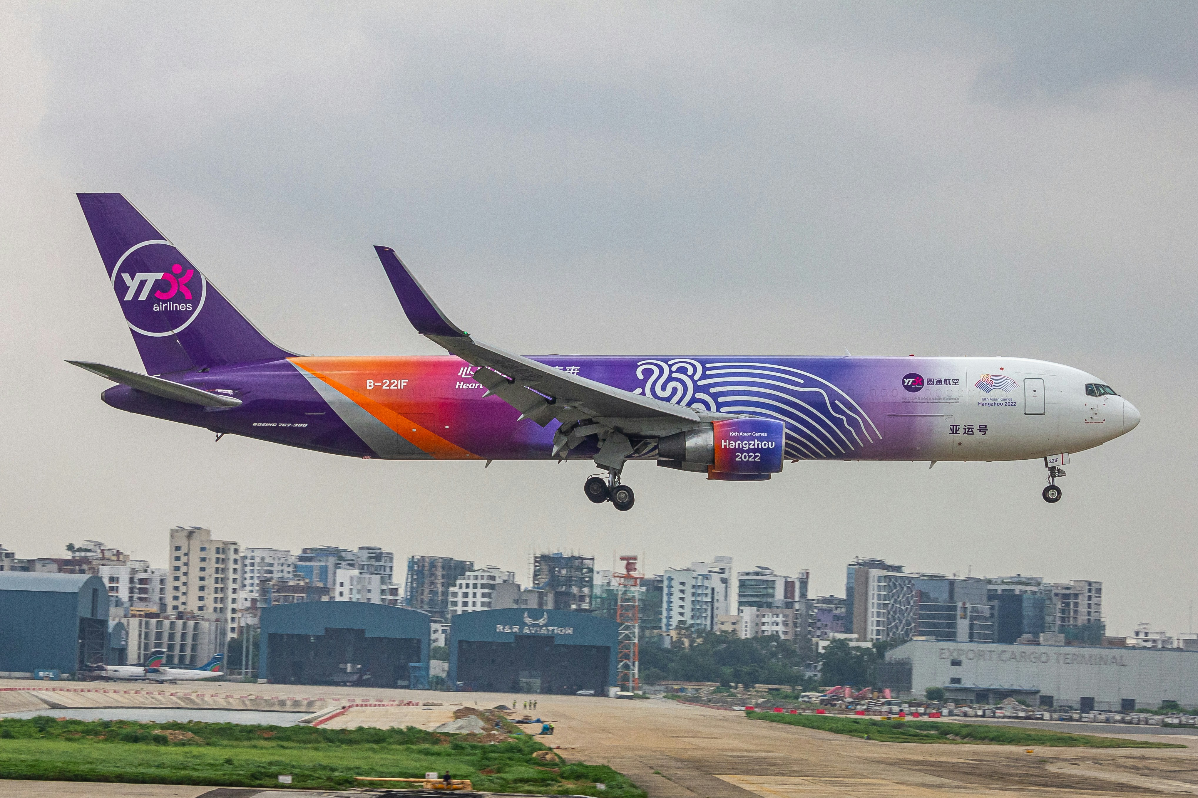 A large jetliner flying through a cloudy sky, YTO Cargo Airlines B763
