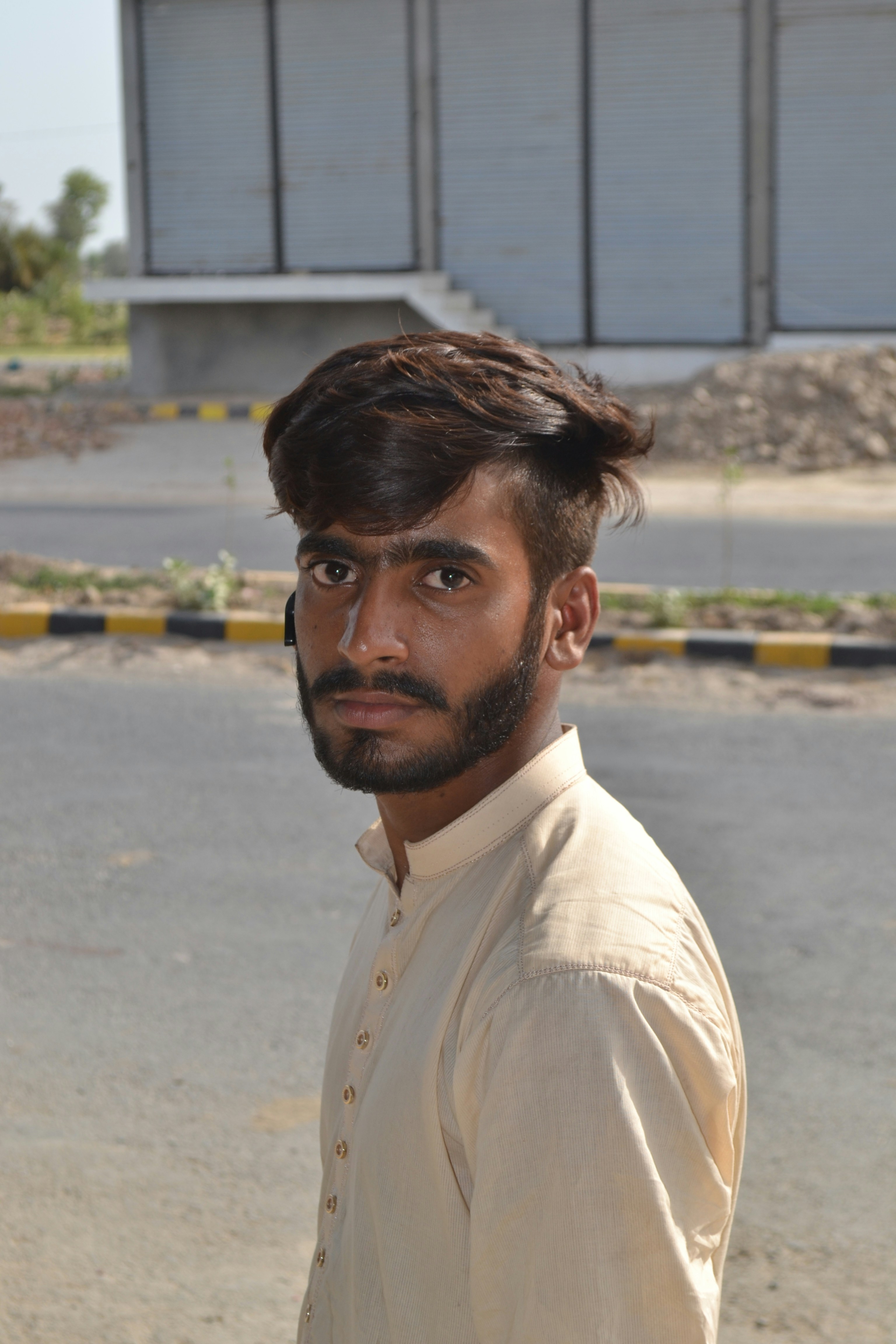 Dev Anand with dark hair and beard outdoors