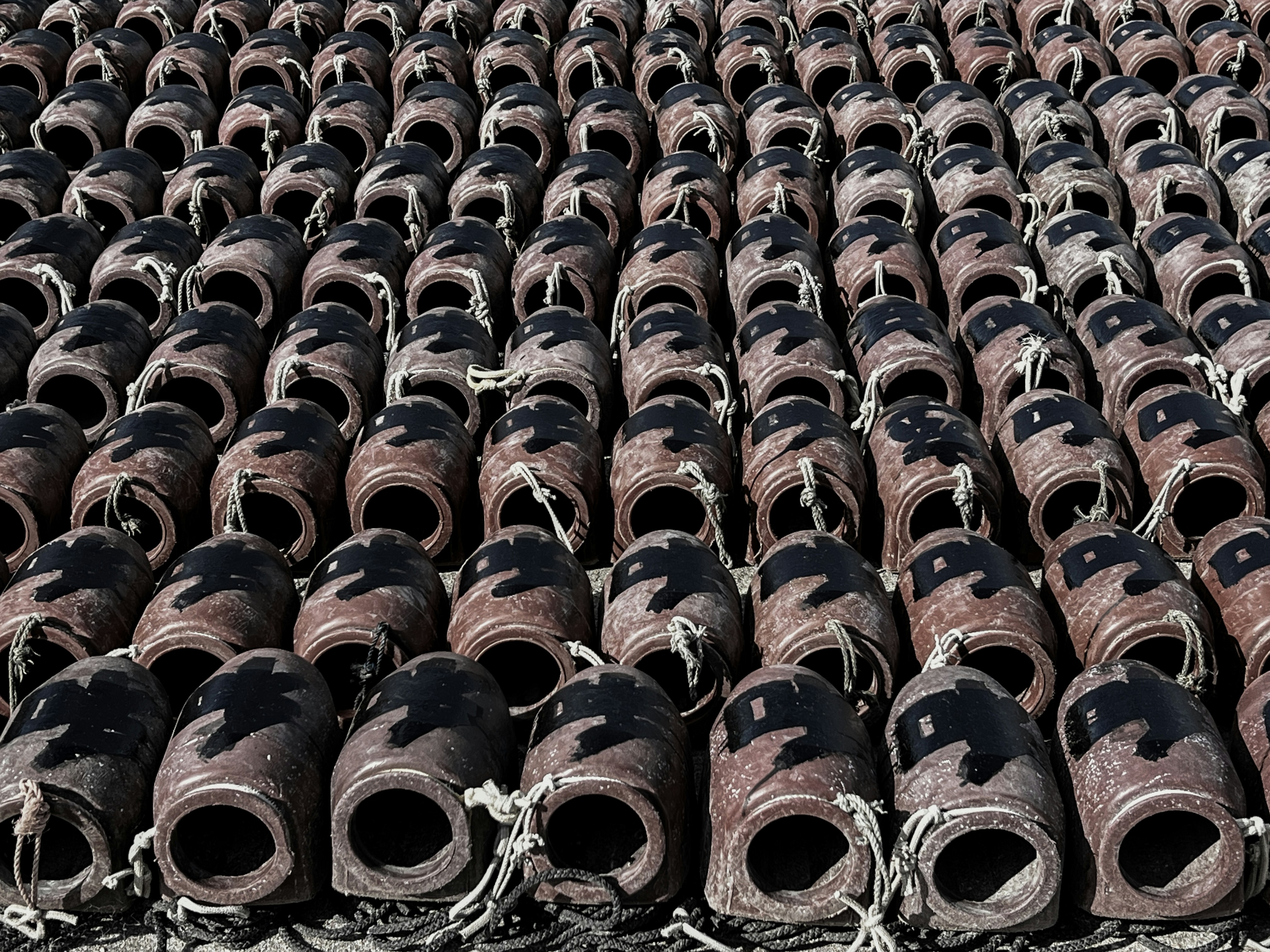 A large amount of old, worn out shoes are stacked together