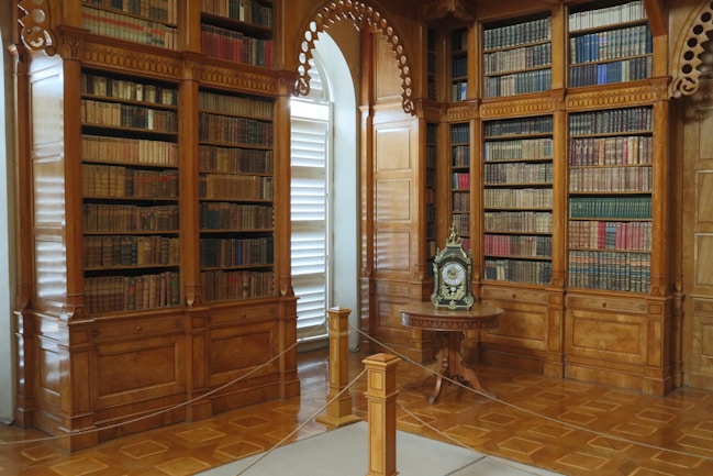 A room filled with lots of books and a clock