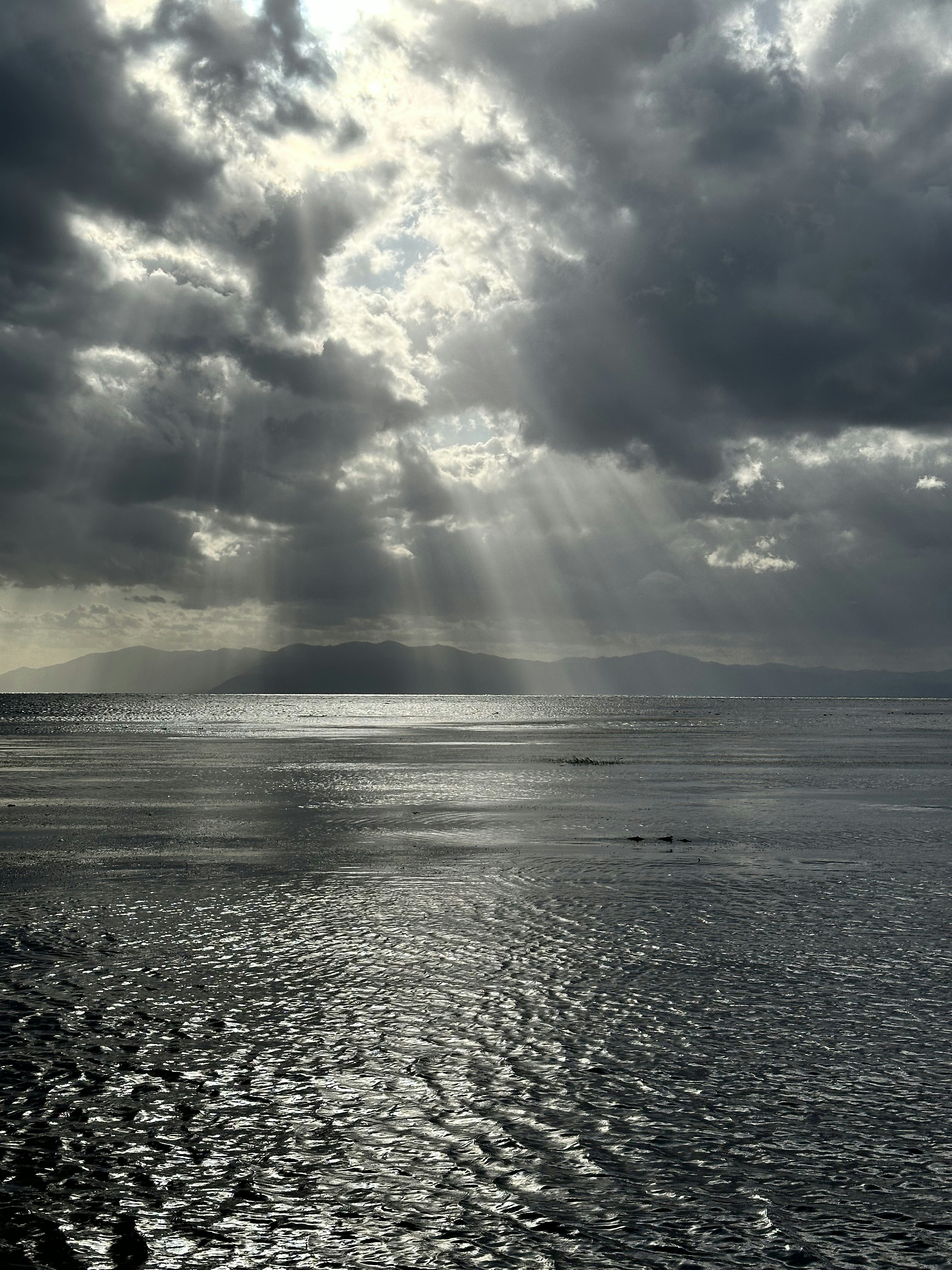 A large body of water under a cloudy sky