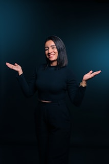 A woman standing in front of a black background