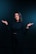A woman standing in front of a black background