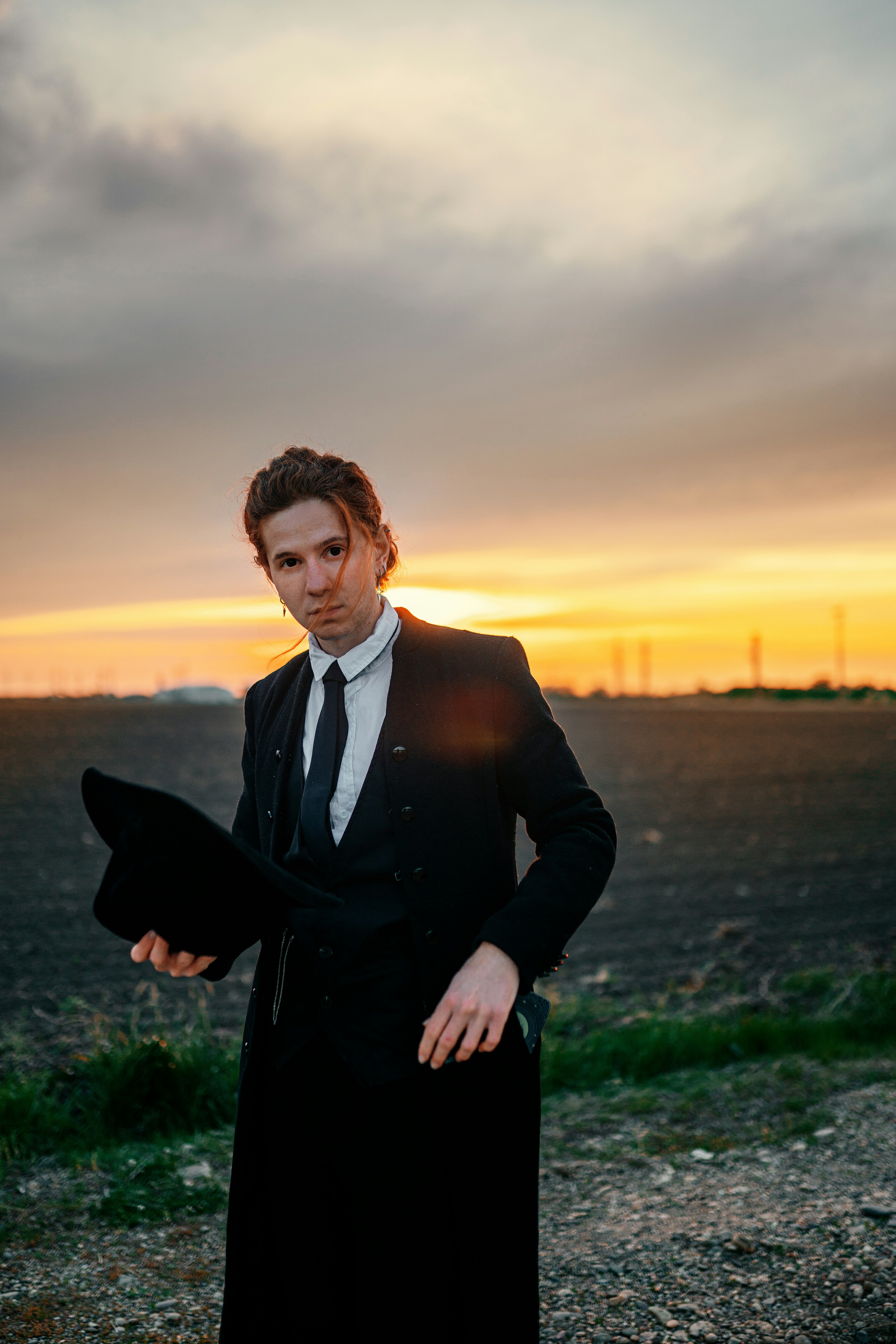 A man in a suit and tie standing in a field photo – Free Hat Image on ...