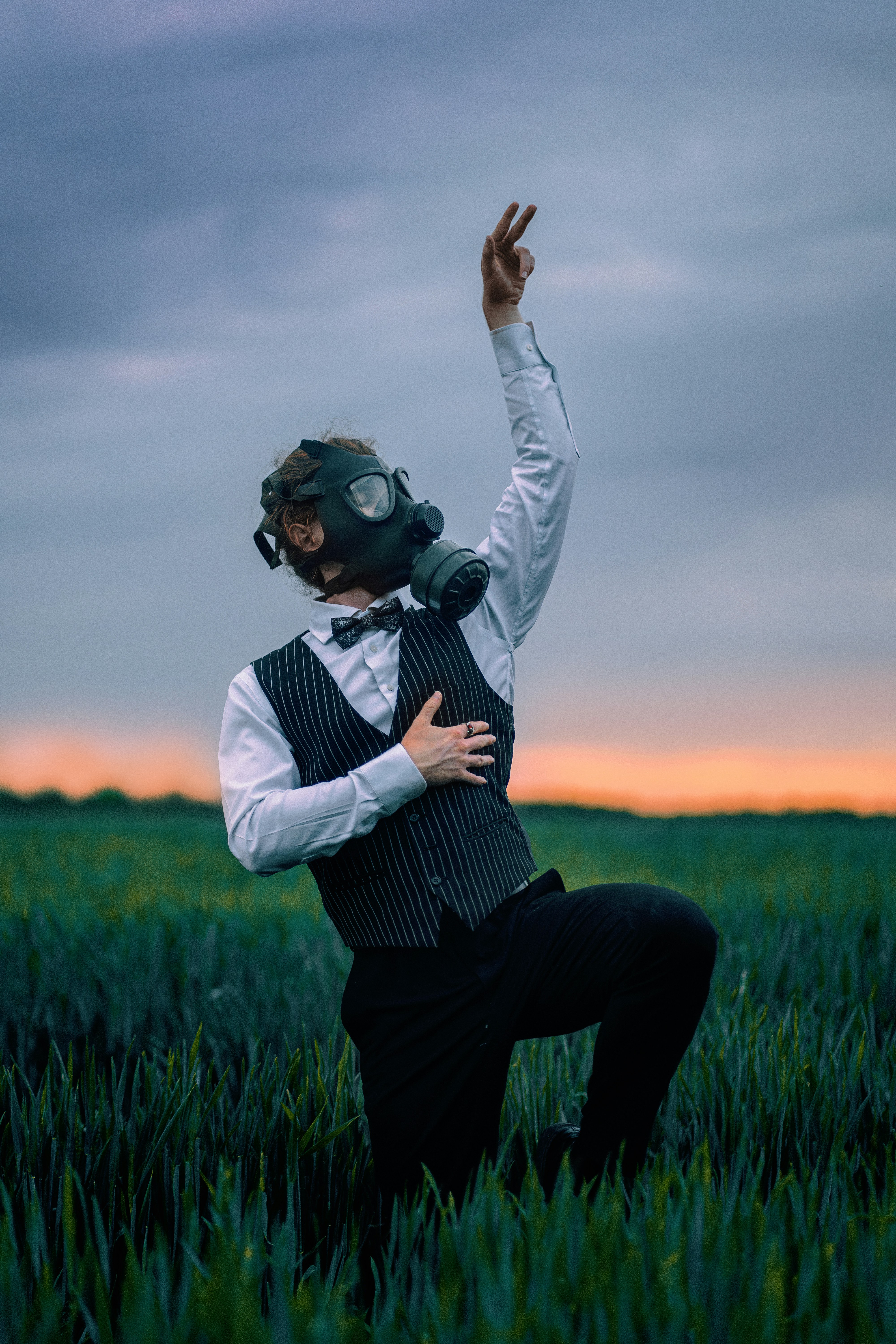 A man wearing a gas mask in a field