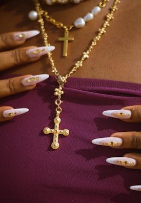 A woman wearing a necklace with a cross on it