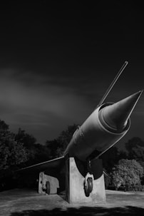 A black and white photo of a rocket on display