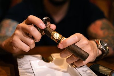 A man is holding a cigar in his hand