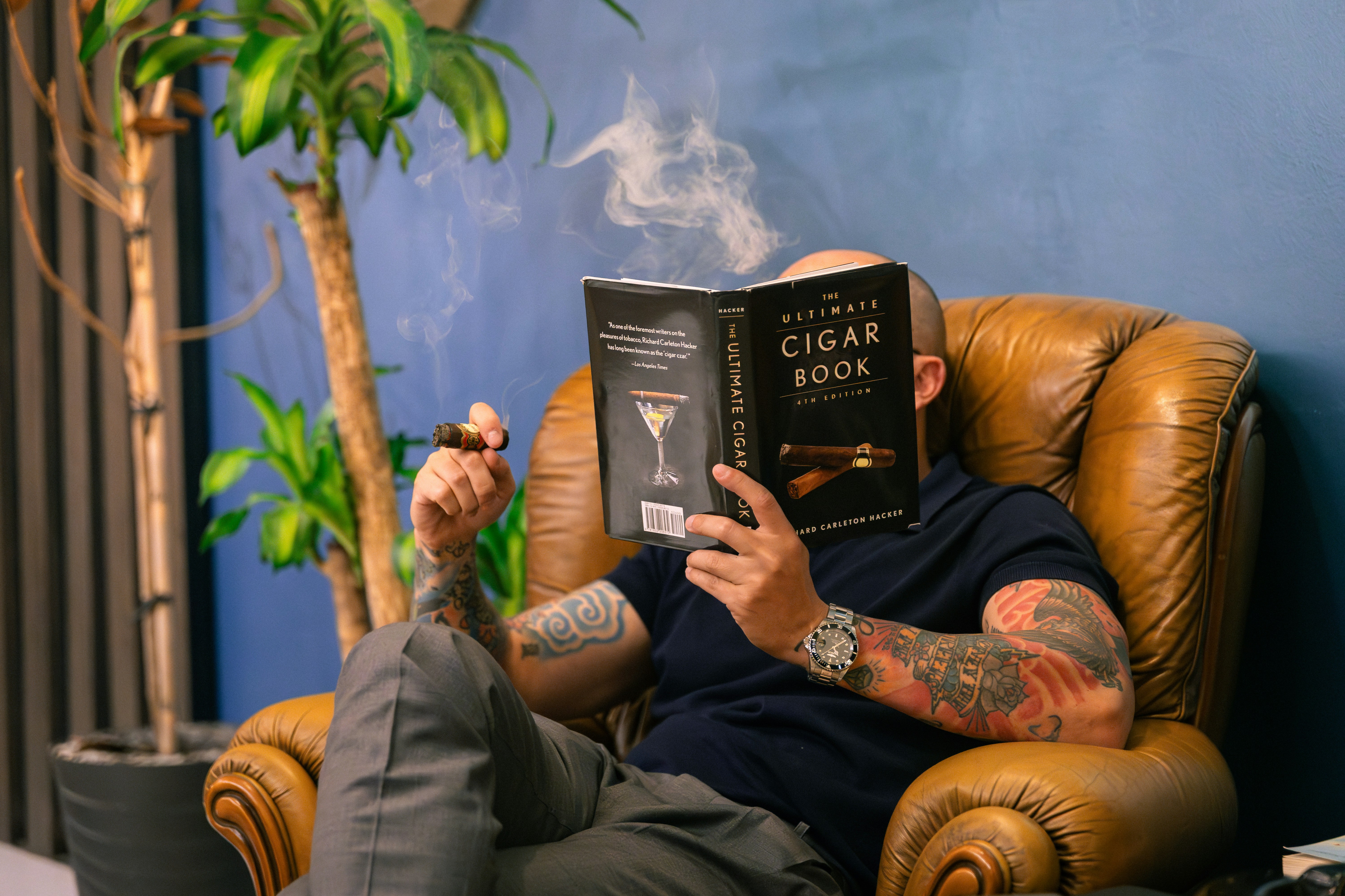 A man sitting in a chair reading a book