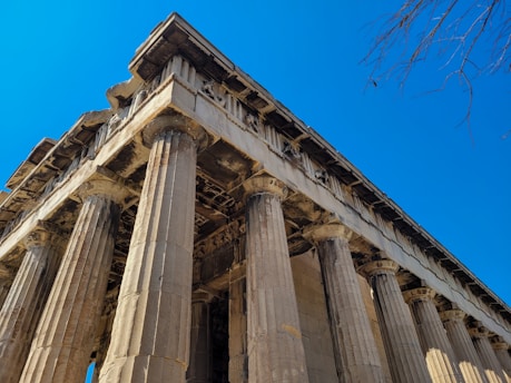 A very tall building with some columns on top of it