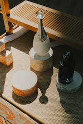 A wooden table topped with a bottle of wine